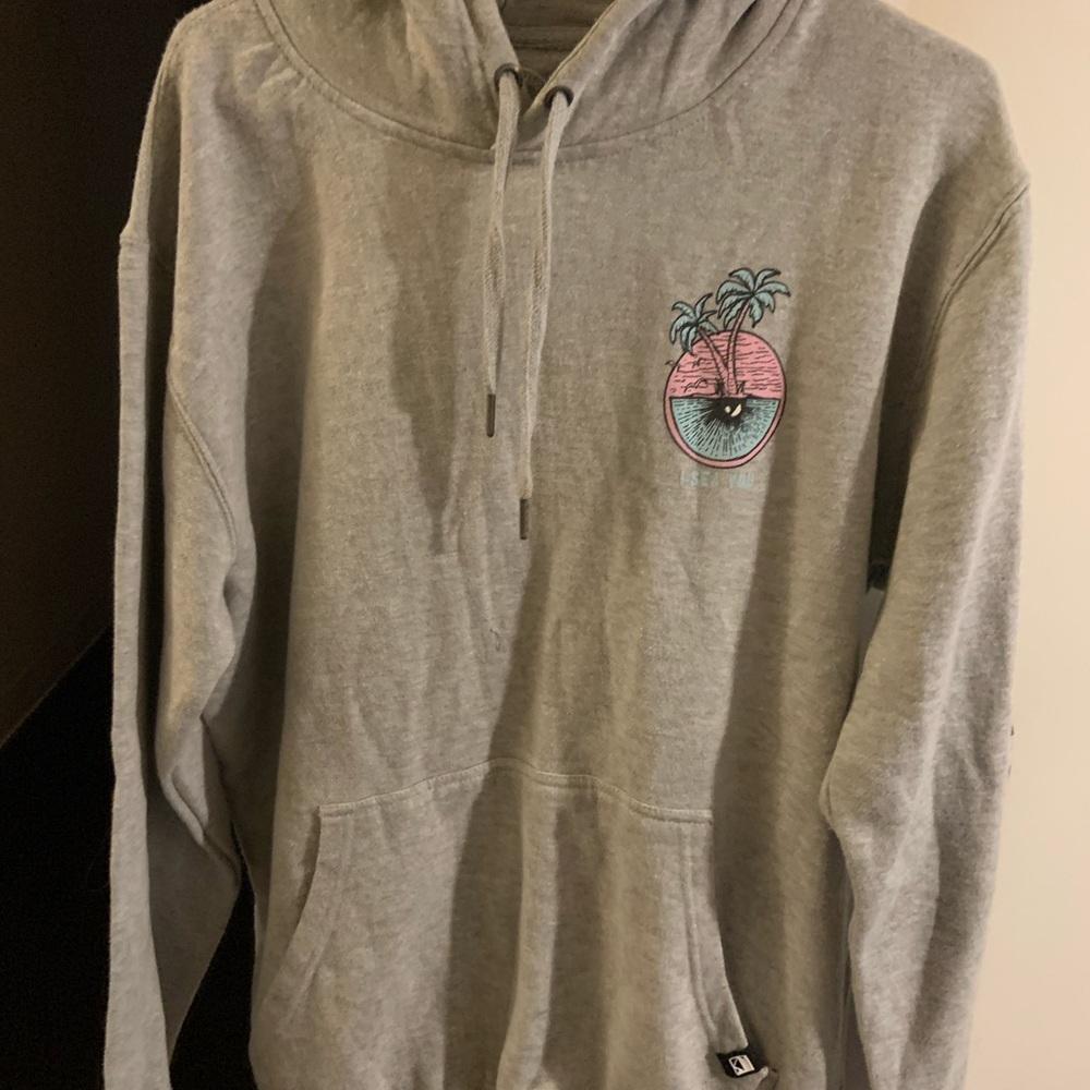 grey hoodie with small symbol